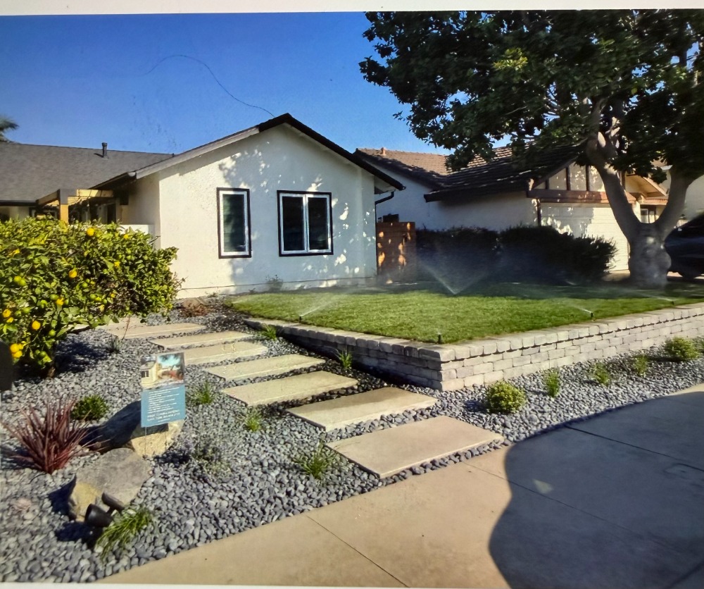 Irrigation and sprinkler system watering a front lawn